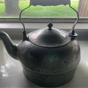 Vintage metal teapot with wood handle.